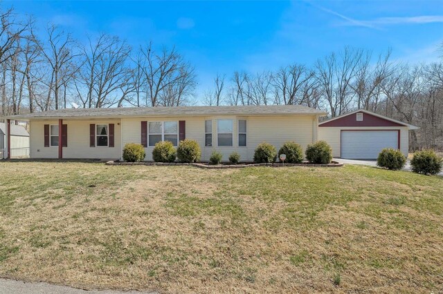 ranch-style house with an outdoor structure, a front lawn, and a detached garage