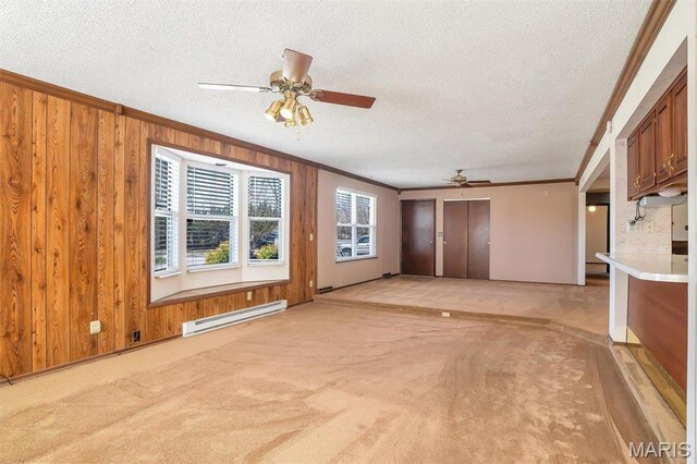 6072 Kingsway, House Springs, MO 63051 - unfurnished living room with ceiling fan, a baseboard heating unit, ornamental molding, a textured ceiling, and wooden walls