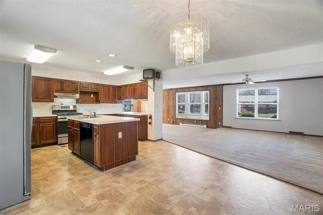 6072 Kingsway, House Springs, MO 63051 - kitchen with appliances with stainless steel finishes, under cabinet range hood, light countertops, a sink, and a textured ceiling