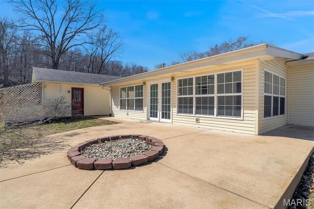 6072 Kingsway, House Springs, MO 63051 - back of house featuring a patio area and a fire pit