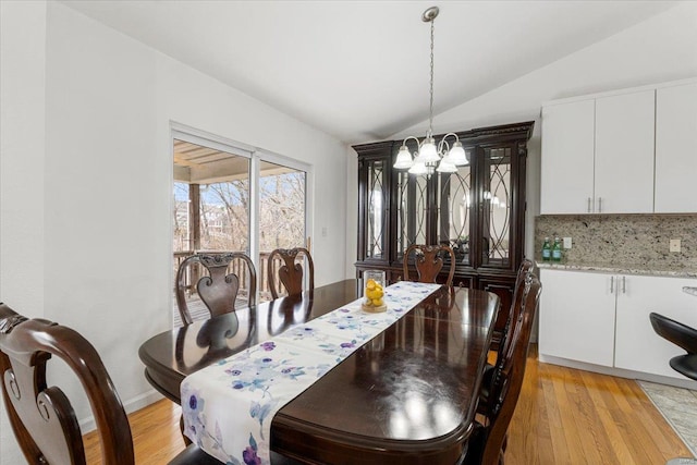 9 Amber Ridge Ct, High Ridge, MO 63049 - dining room featuring a chandelier, lofted ceiling, and light wood-type flooring