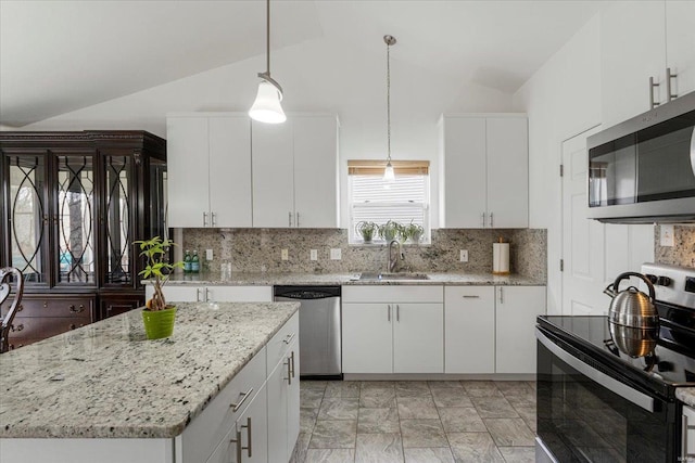 9 Amber Ridge Ct, High Ridge, MO 63049 - kitchen with stainless steel appliances, a sink, lofted ceiling, white cabinets, and backsplash