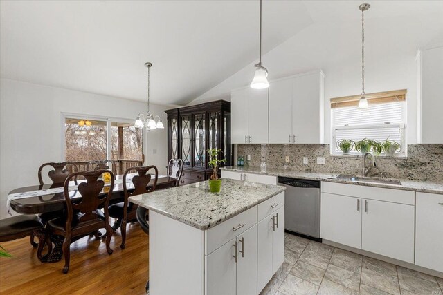9 Amber Ridge Ct, High Ridge, MO 63049 - kitchen with stainless steel dishwasher, a sink, lofted ceiling, backsplash, and a kitchen island