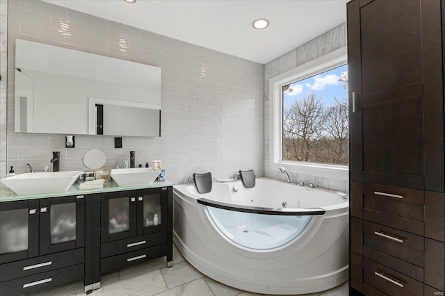 9 Amber Ridge Ct, High Ridge, MO 63049 - bathroom with tile walls, marble finish floors, a tub with jets, double vanity, and recessed lighting