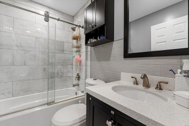 9 Amber Ridge Ct, High Ridge, MO 63049 - bathroom with toilet, tile walls, bath / shower combo with glass door, vanity, and backsplash
