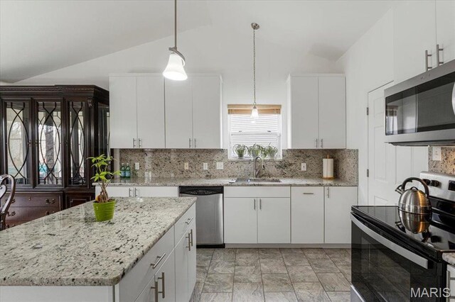 9 Amber Ridge Ct, High Ridge, MO 63049 - kitchen featuring appliances with stainless steel finishes, a sink, vaulted ceiling, and white cabinetry
