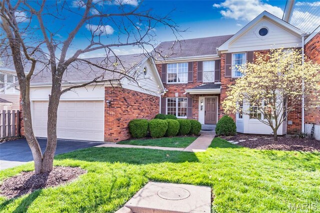 14 Webster Oaks Dr, Webster Groves, MO 63119 - traditional home with brick siding, driveway, a front lawn, and an attached garage