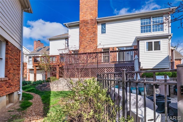 14 Webster Oaks Dr, Webster Groves, MO 63119 - rear view of house with a chimney and a wooden deck