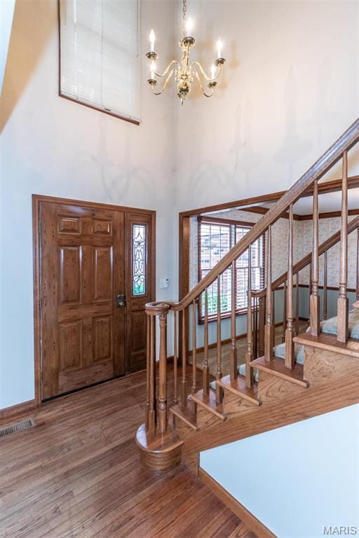 14 Webster Oaks Dr, Webster Groves, MO 63119 - entryway featuring a chandelier, wood finished floors, stairway, and a towering ceiling