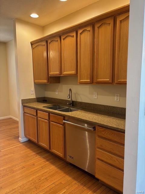 708 Michael St, Ofallon, IL 62269 - kitchen featuring dishwasher, a sink, dark countertops, light wood finished floors, and recessed lighting