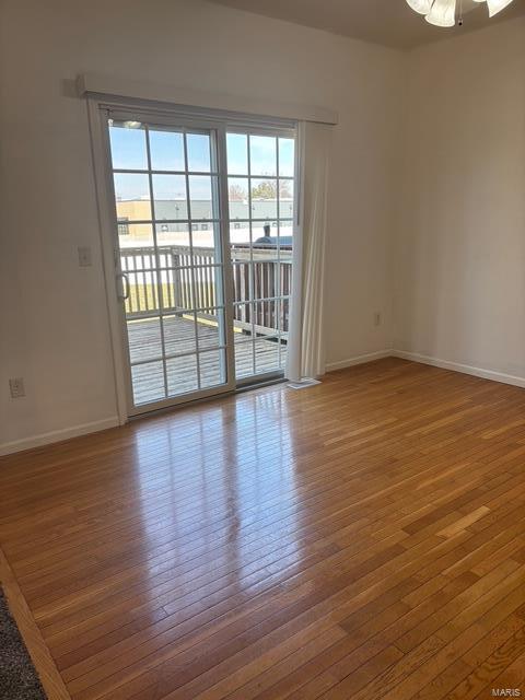 708 Michael St, Ofallon, IL 62269 - spare room featuring hardwood / wood-style floors, baseboards, and ceiling fan