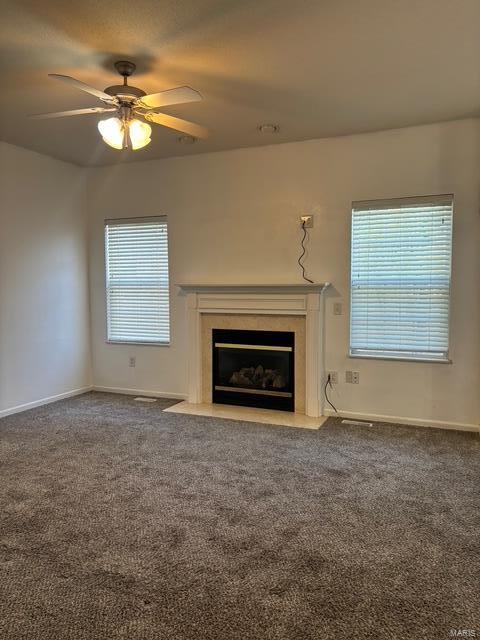 708 Michael St, Ofallon, IL 62269 - unfurnished living room featuring a premium fireplace, carpet flooring, ceiling fan, and healthy amount of natural light