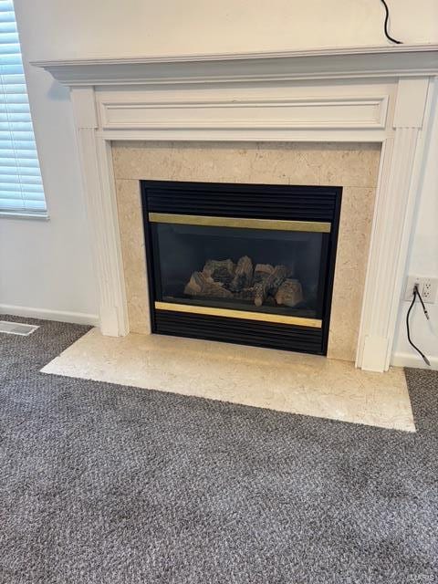 708 Michael St, Ofallon, IL 62269 - detailed view of a glass covered fireplace, carpet flooring, and baseboards