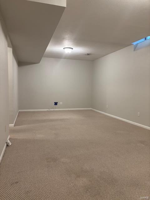 708 Michael St, Ofallon, IL 62269 - below grade area featuring baseboards and light colored carpet