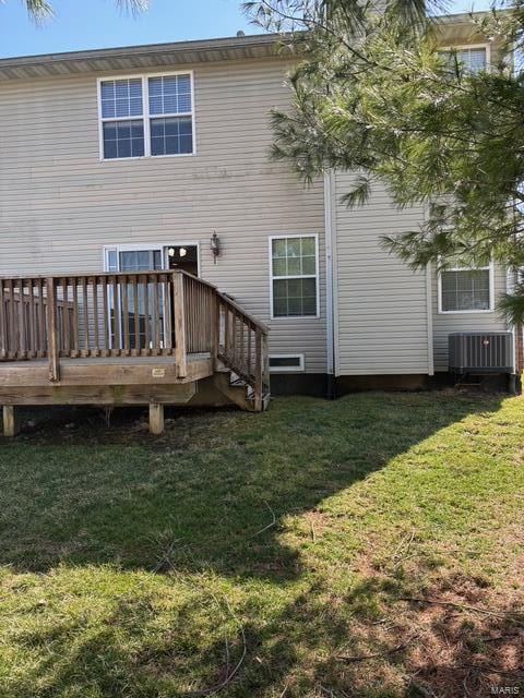 708 Michael St, Ofallon, IL 62269 - back of property with central AC unit, a deck, and a lawn