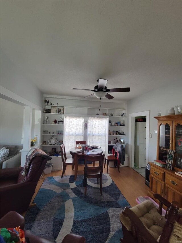 dining room with a ceiling fan and wood finished floors