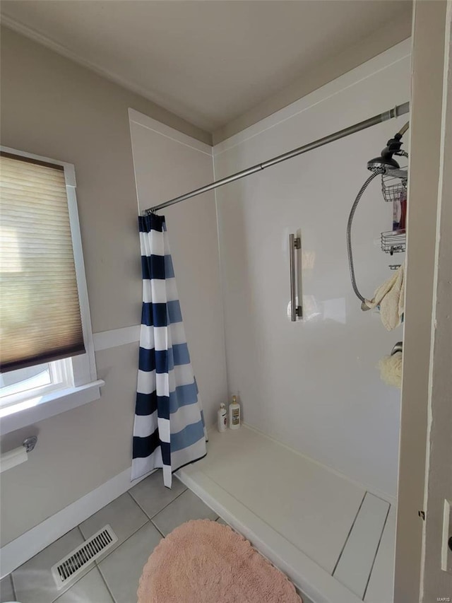 full bath with a shower with curtain and tile patterned flooring