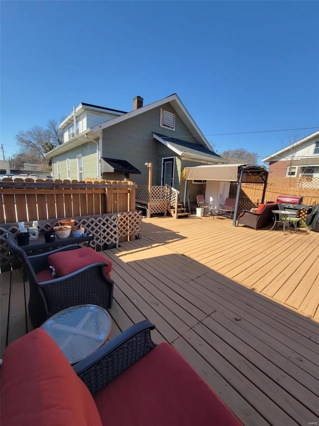 wooden terrace featuring fence
