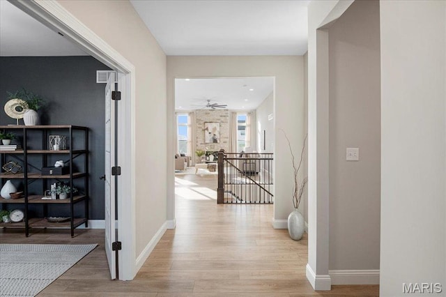 504 Coppice Ct, Wentzville, MO 63385 - hallway with wood finished floors, baseboards, and an upstairs landing