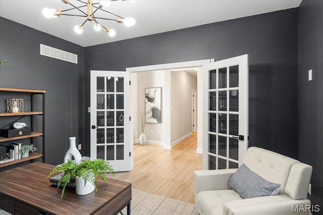504 Coppice Ct, Wentzville, MO 63385 - living area with wood finished floors, a chandelier, and baseboards