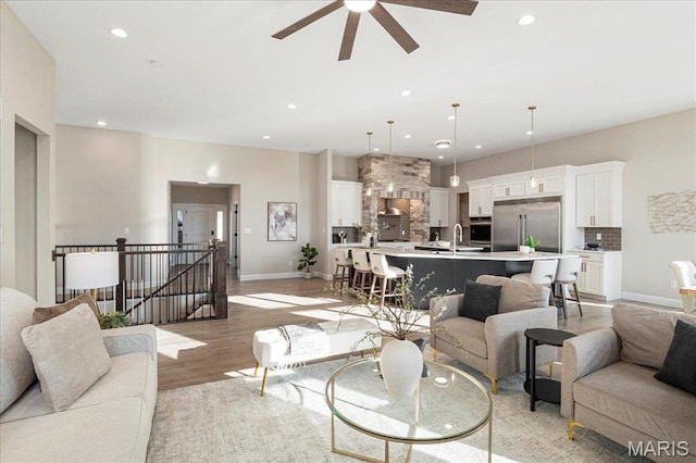 504 Coppice Ct, Wentzville, MO 63385 - living room featuring recessed lighting, light wood-style flooring, a ceiling fan, and baseboards