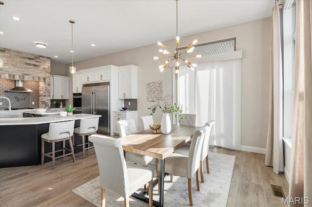 504 Coppice Ct, Wentzville, MO 63385 - dining space featuring light wood-type flooring, a chandelier, recessed lighting, and baseboards