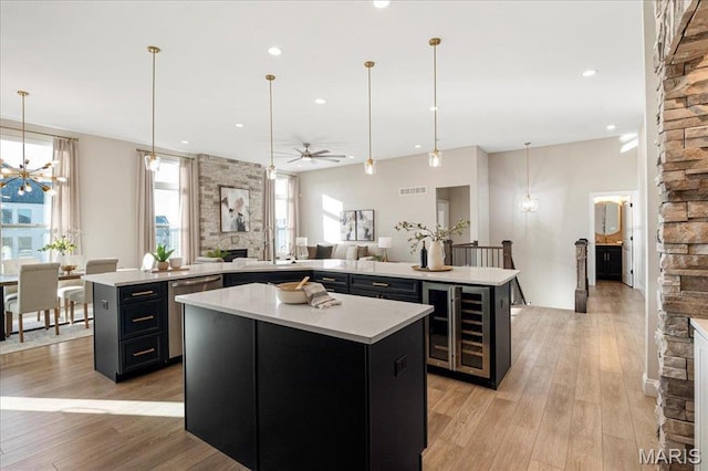 504 Coppice Ct, Wentzville, MO 63385 - kitchen featuring a spacious island, beverage cooler, stainless steel dishwasher, a stone fireplace, and dark cabinets
