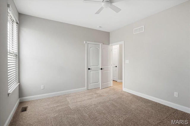 504 Coppice Ct, Wentzville, MO 63385 - unfurnished bedroom featuring multiple windows, carpet flooring, and baseboards