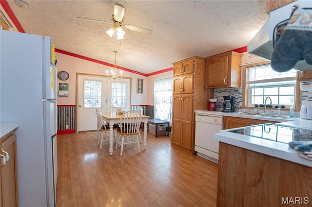 751 High St, Edgar Springs, MO 65462 - kitchen featuring white appliances, vaulted ceiling, brown cabinets, a textured ceiling, and light wood-type flooring