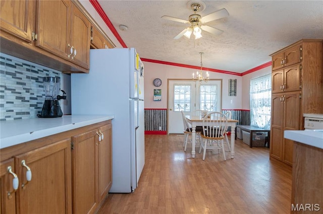 751 High St, Edgar Springs, MO 65462 - kitchen with freestanding refrigerator, brown cabinetry, ceiling fan, a textured ceiling, and ornamental molding