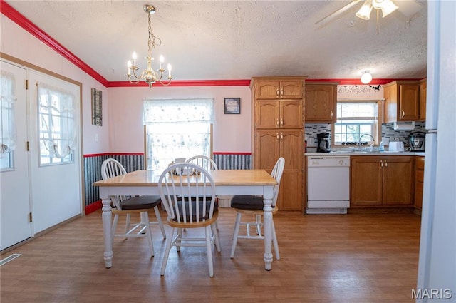 751 High St, Edgar Springs, MO 65462 - dining space with a textured ceiling, light wood finished floors, wainscoting, a chandelier, and crown molding