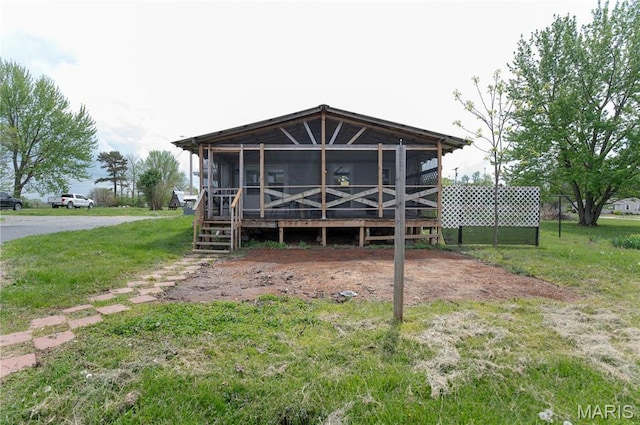 751 High St, Edgar Springs, MO 65462 - rear view of property featuring a sunroom and a lawn