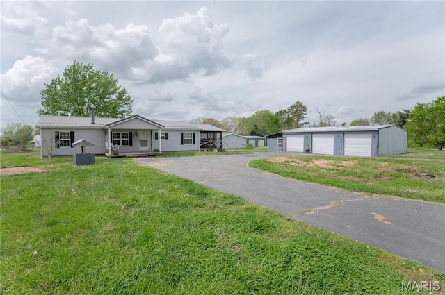 751 High St, Edgar Springs, MO 65462 - view of front facade featuring an outdoor structure, a garage, a front yard, and a porch