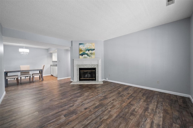 1593 Thrush Ter, Brentwood, MO 63144 - unfurnished living room featuring dark wood-style floors, a textured ceiling, and baseboards
