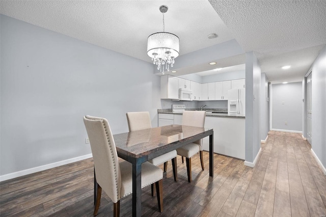 1593 Thrush Ter, Brentwood, MO 63144 - dining room with a textured ceiling, wood finished floors, a chandelier, baseboards, and recessed lighting