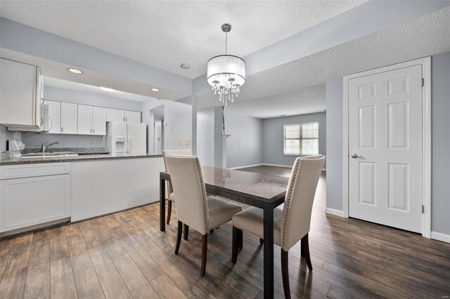 1593 Thrush Ter, Brentwood, MO 63144 - dining space with a chandelier, a textured ceiling, dark wood-type flooring, recessed lighting, and baseboards