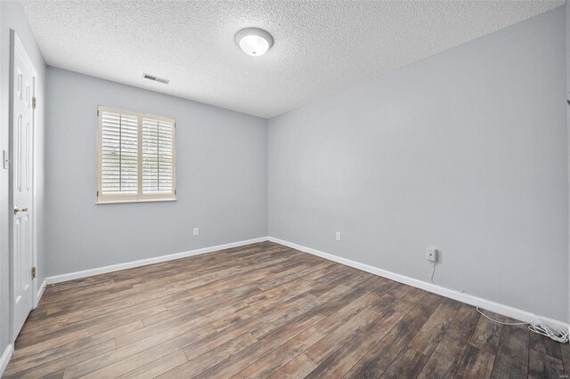 1593 Thrush Ter, Brentwood, MO 63144 - spare room with wood finished floors, a textured ceiling, and baseboards