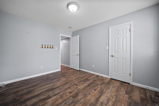 1593 Thrush Ter, Brentwood, MO 63144 - unfurnished bedroom featuring wood finished floors, a textured ceiling, and baseboards