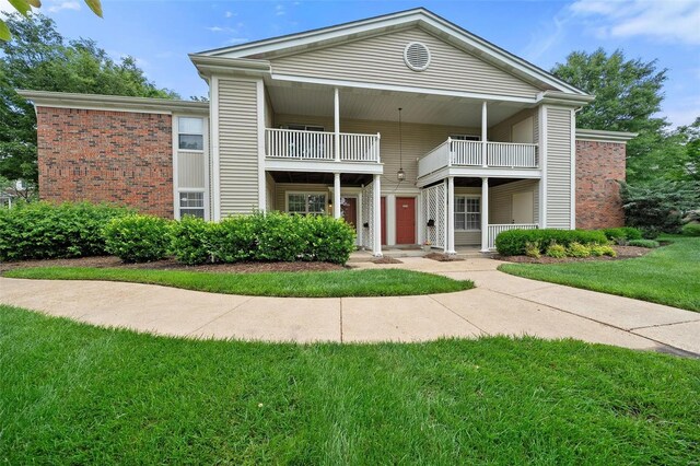1593 Thrush Ter, Brentwood, MO 63144 - view of front of property featuring a balcony, brick siding, and a front lawn