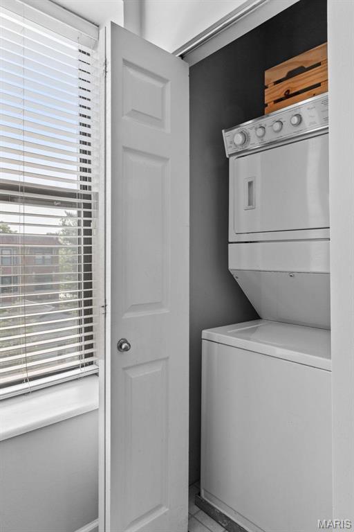 5653 Waterman Blvd Unit 3N, Saint Louis, MO 63112 - laundry area with estacked washer and dryer and tile patterned flooring