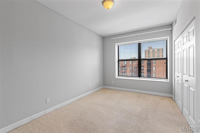 5653 Waterman Blvd Unit 3N, Saint Louis, MO 63112 - unfurnished bedroom featuring carpet flooring, baseboards, and a closet