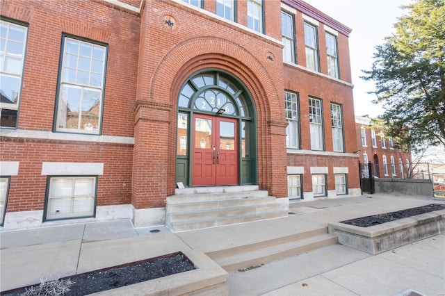 property entrance featuring brick siding