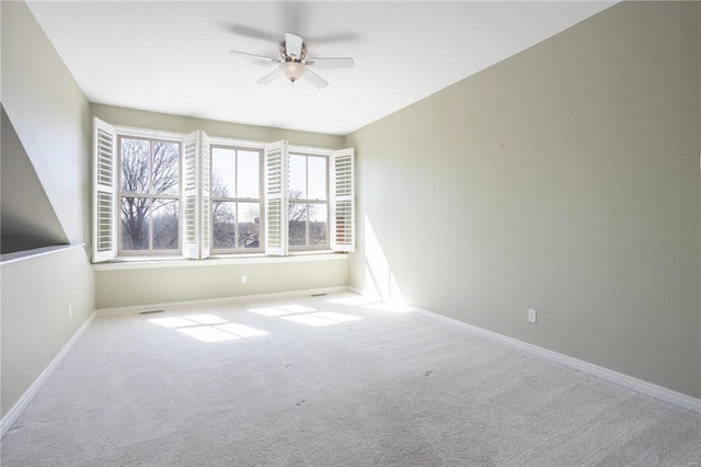 empty room with a ceiling fan, carpet flooring, and baseboards