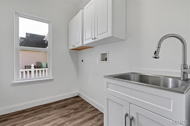 washroom with washer hookup, cabinet space, baseboards, dark wood-style flooring, and hookup for an electric dryer
