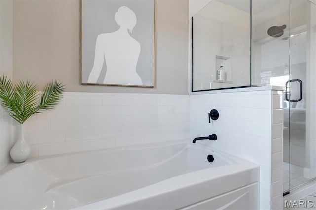 bathroom featuring a stall shower and a garden tub