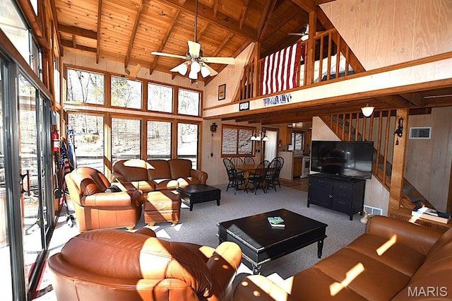 living area with wood ceiling, ceiling fan, carpet flooring, beamed ceiling, and high vaulted ceiling