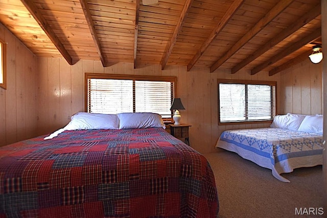 carpeted bedroom with beamed ceiling, wooden walls, and wooden ceiling