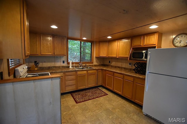 856 Aspen Lake Dr, Innsbrook, MO 63390 - kitchen featuring white appliances, dark countertops, recessed lighting, brown cabinetry, and light floors