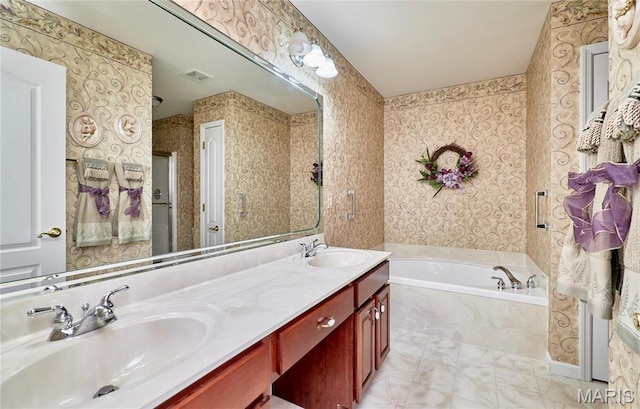 bathroom with a garden tub, wallpapered walls, and double vanity
