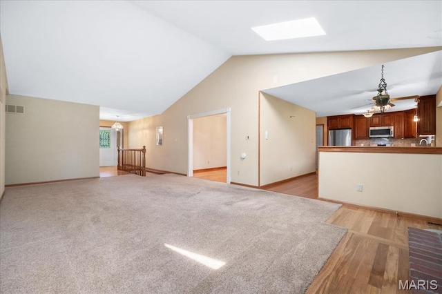 221 Greiner Ct, Ellisville, MO 63021 - unfurnished living room with lofted ceiling, a skylight, ceiling fan, and light wood-type flooring